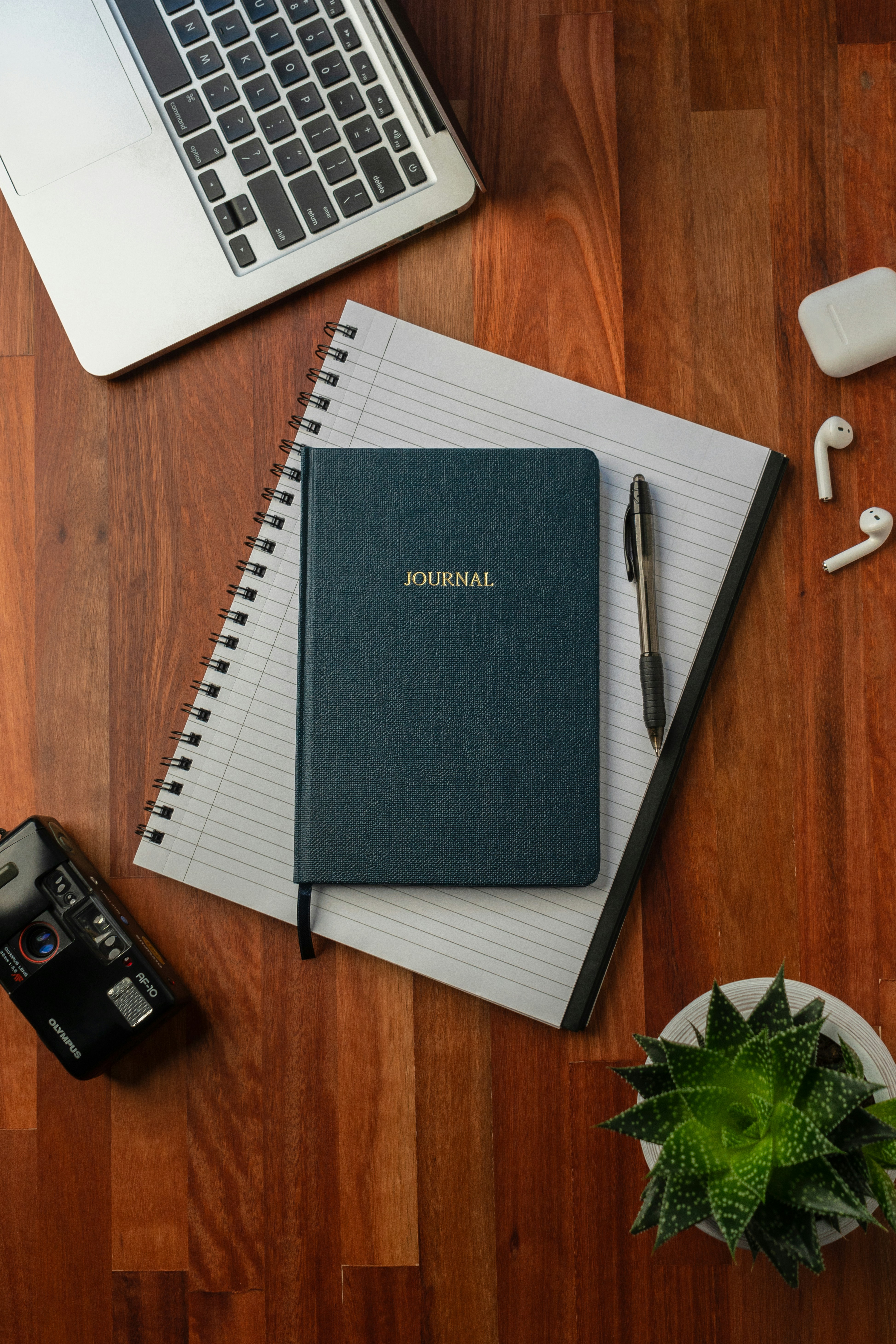 Laptop and notebook workspace for planning a job post